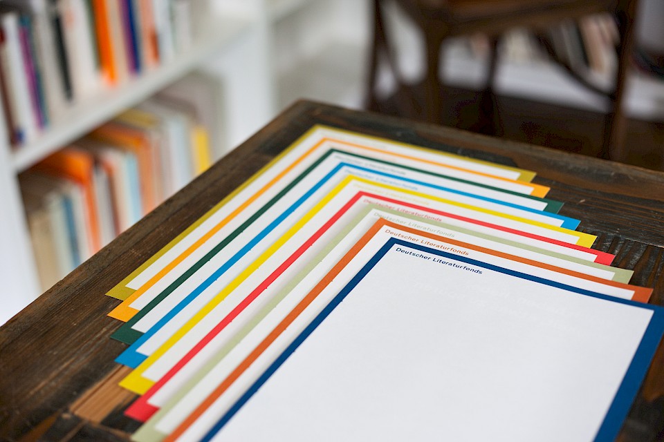 The variegated letterheads are reminiscent of book spines on the shelf